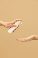 Hygiene. Female Hands Using Antiseptic Gel On Beige Background. Daily Routine With Antibacterial Products For Virus Prevention And Staying Healthy.