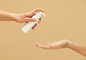 Sanitizer. Female Hands Using Antiseptic Gel On Beige Background. Daily Hygiene Routine With Antibacterial Products For Virus Prevention And Staying Healthy.