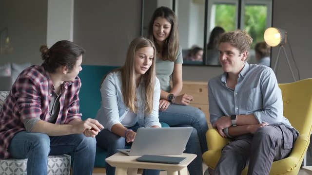 group of young people working on a laptop