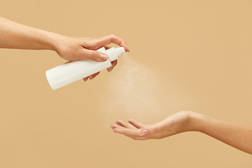 Sanitizer. Female Hands Using Spray Antiseptic On Beige Background. Daily Hygiene Routine With Antibacterial Products For Virus Prevention And Staying Healthy.