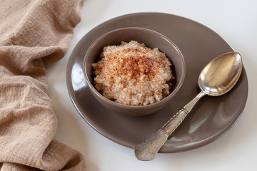 Spelled porridge with cinnamon. Proper nutrition concept. 