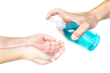 Closeup of father pushing alcohol sanitizer gel pump dispenser to son hand - people with alcohol sanitizer prevent bacterias and COVID-19 virus protection concept.