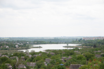 Obraz premium Village by the river under a clear blue sky in the summer