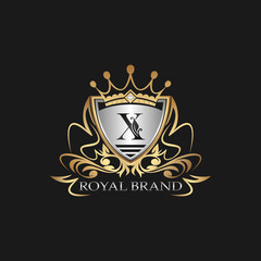 X Letter Gold Shield Logo. Elegant vector logo badge template with alphabet letter on shield frame ornate vector style  design.