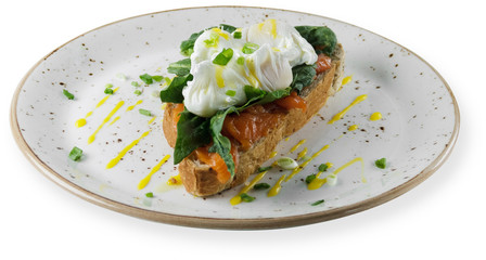 Bruschetta with poached egg and smoked salmon. white background.