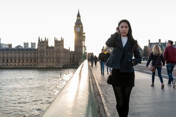 Asian businesswoman near Big Ben, London, England. Girl in London during winter near Westminster...