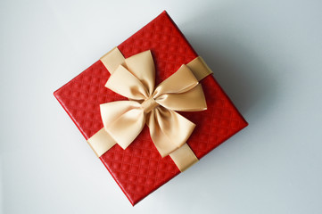 Red box with a big bow. Packing for a gift.