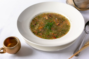 Mushroom soup in white bowl. Close-up view.