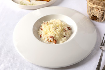 Close-up risotto with chanterelle mushrooms and grated parmesan