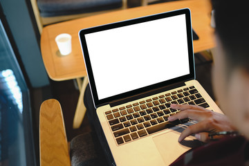 Close up of man using blank laptop order products  for shopping online within the cafe.