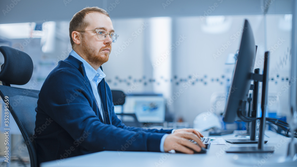 Aufkleber shot of a heavy industry engineer working on personal computer in modern industrial factory with hig