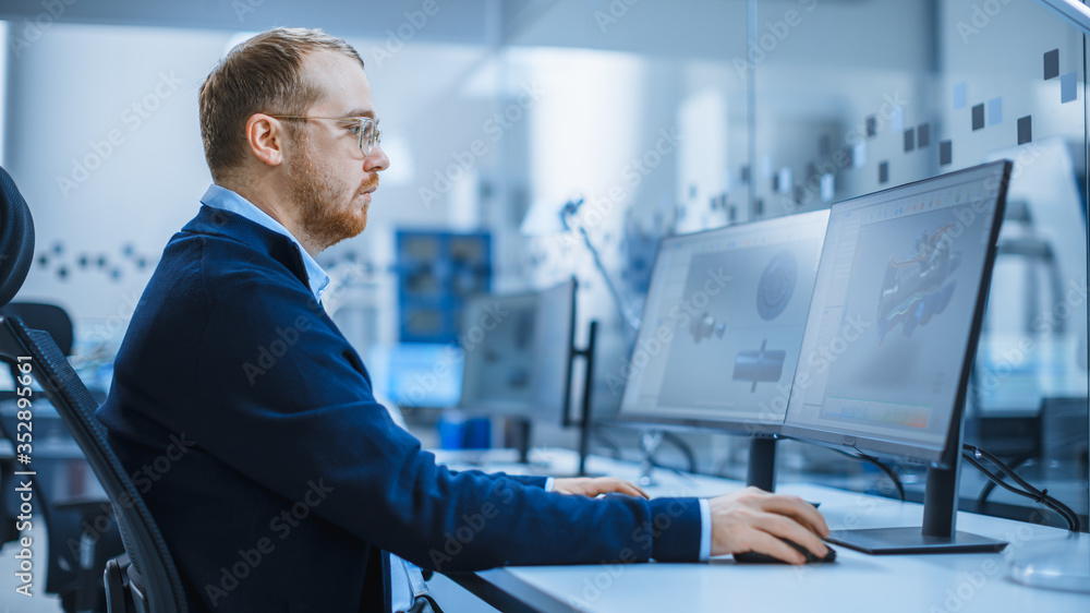 Aufkleber Shot of a Heavy Industry Engineer Working on Personal Computer, Screen Shows CAD Software Showing New Generation Electric Engine. Industrial Factory with High-Tech CNC Machinery