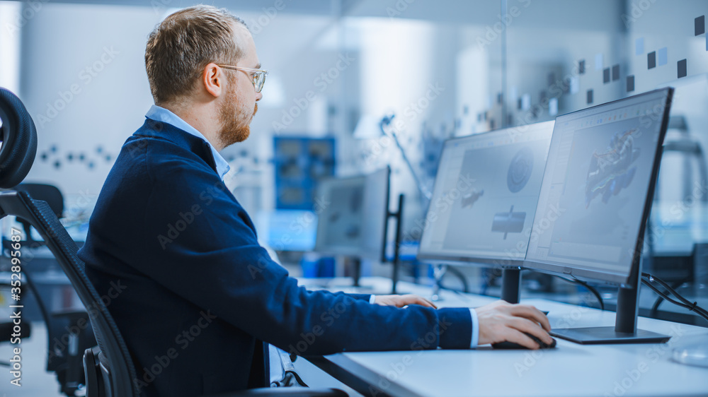 Aufkleber Industrial Engineer Working on a Personal Computer with Two Monitors Showing CAD Software with 3D Prototype of Hybrid Electric Engine and Charts. Modern Factory with High-Tech Machinery