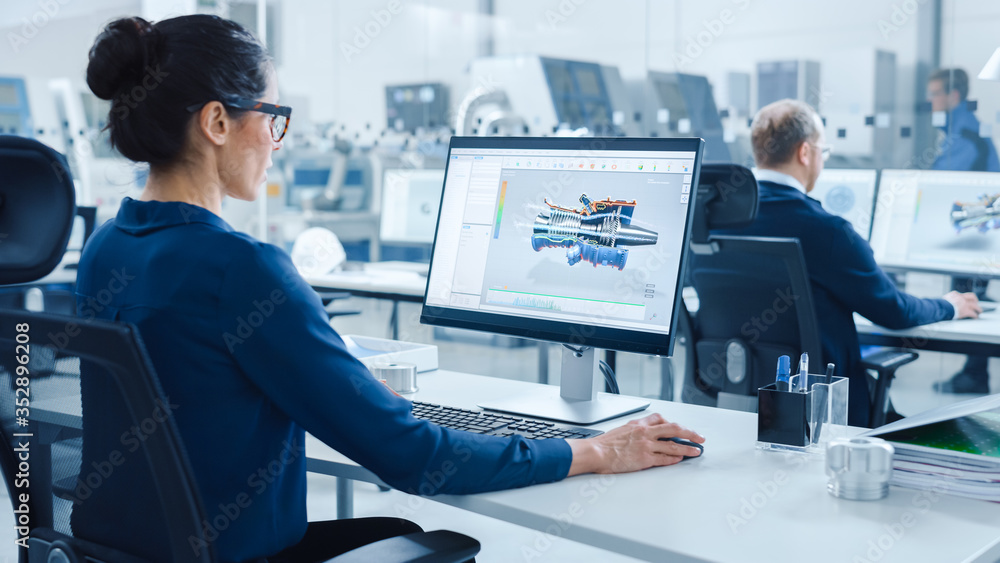 Aufkleber Industrial female Engineer Working on a Personal Computer, Screen Shows CAD Software with 3D Prototype of Engine. Busy Factory with Professional Workers High-Tech Machinery