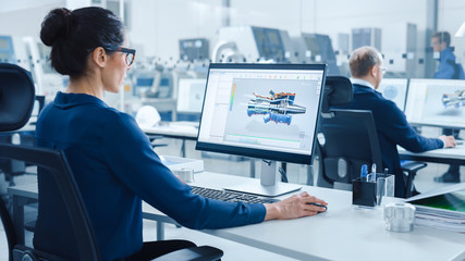 Industrial female Engineer Working on a Personal Computer, Screen Shows CAD Software with 3D...