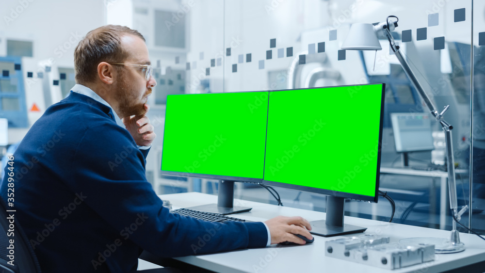 Aufkleber industrial engineer working on a personal computer, two monitor screens are mock-up, green screen, c