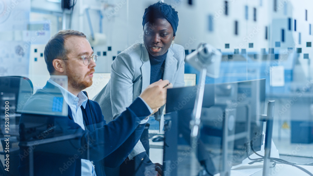Poster modern electronic factory: female project manager talks to male electrical engineer who works on com