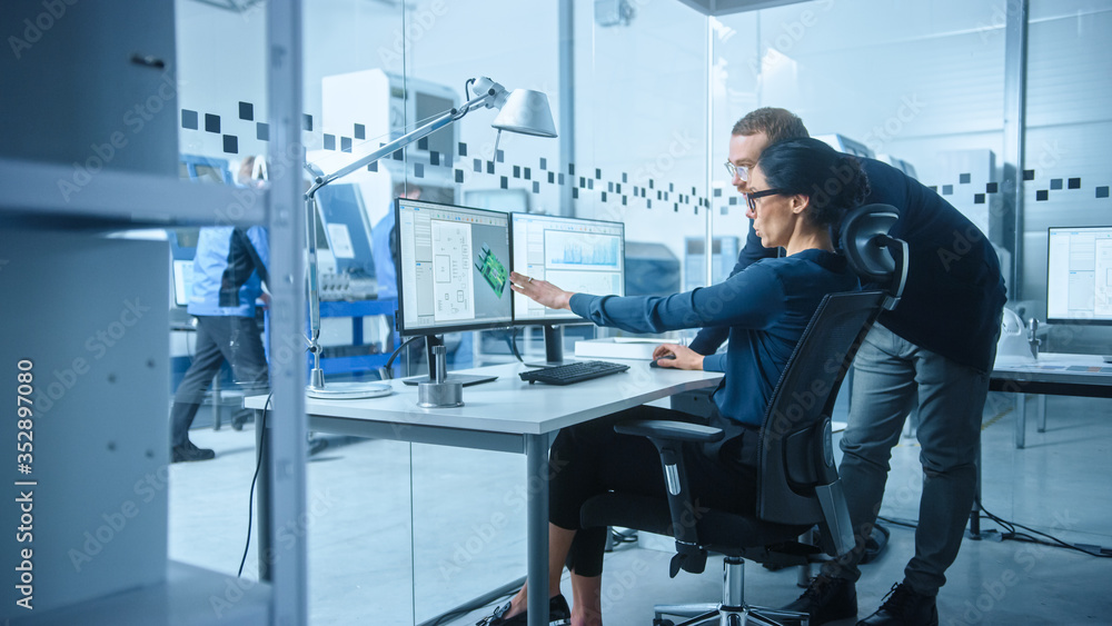 Poster modern electronics factory: male supervisor talks to a female electrical engineer who works on compu