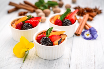 Dessert with fresh fruits on wooden background.