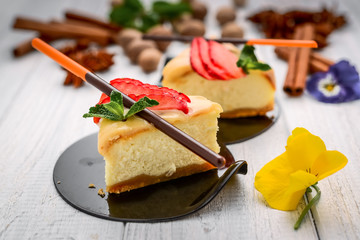 Slice of cheesecake with berries on wooden background