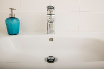 Interior of bathroom with sink basin faucet and blue soap. Design of bathroom
