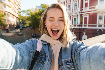 Beautiful young blonde woman wearing denim jacket