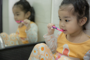 Little asian cute girl brush teeth