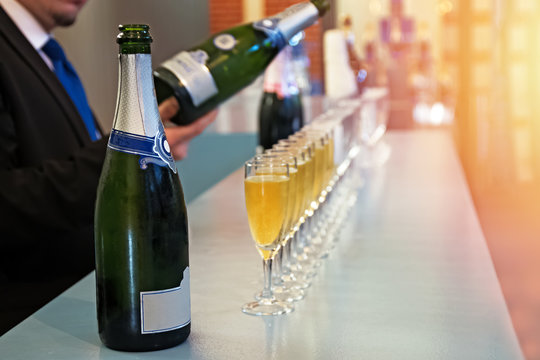 Row of glasses with sparkling wine, champagne or proseco close-up. Wine tasting, warm toned photo