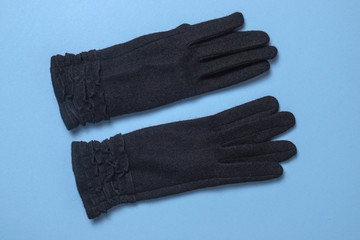 black female gloves on a light blue background