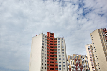 Fototapeta na wymiar Modern East European residential apartment buildings quarter on a sunny day with a blue sky.Abstract architecture, fragment of modern urban geometry