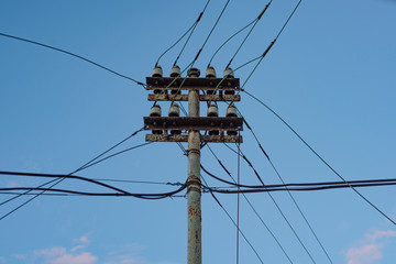 electric pole with dips on a blue background
