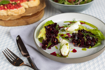Beet root salad with feta cheese on table