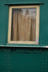 Fototapeta na wymiar old green window in rail wagon