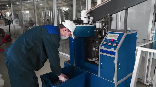 Pure water plant. Work conveyor boosting a liter plastic bottle. Workers monitor the assembly line. 4k