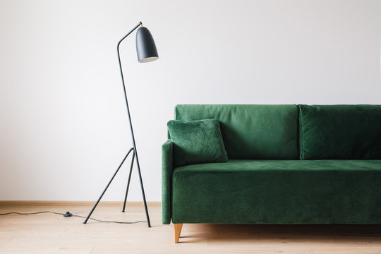 green sofa with pillow near metal modern floor lamp Stock Photo | Adobe  Stock
