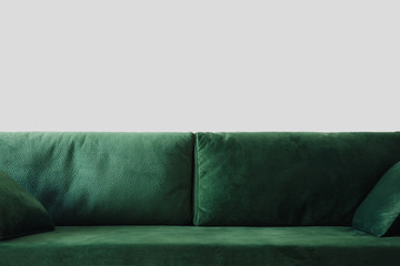 close up view of modern green sofa with pillows in room