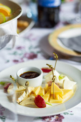 Cheese plates served with grapes, jam with oter dishes