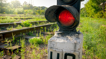 Old semaphore with red light on industrial railroad