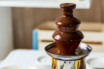 belgian chocolate fountain, fondue close up, selective focus