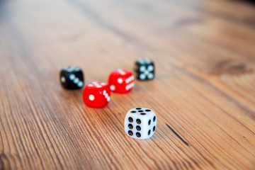 five dice on a wooden table