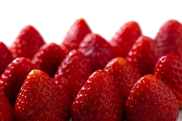 Vivid colorful red strawberries on the strawberries background