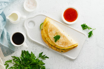 Trendy breakfast with quesadilla and eggs, trending food with omelet, cheese