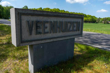 Vintage road sign welcoming you into the small prison town of Veenhuizen in Drenthe, the Netherlands.