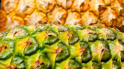Closeup abstract image of green and yellow skin of fresh pineapple