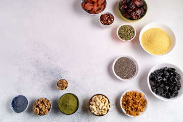 Top view collection of Superfoods and nuts in Bowls for health, fitness and vitality used for preparing energy balls.
