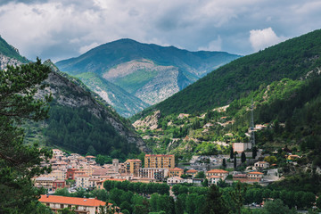 Obraz premium A picturesque wide panoramic view of a French village in the valley of Var in the Alps mountains (Puget-Theniers, Alpes-Maritimes, France)