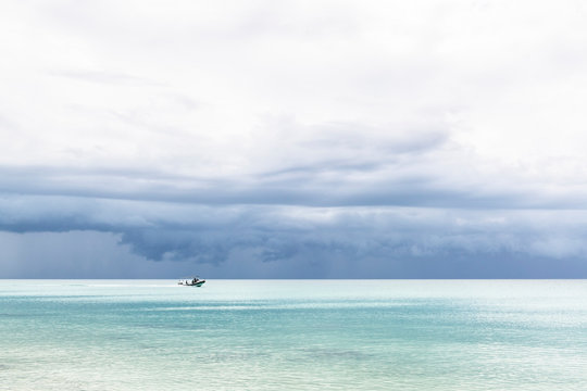Storm clouds building up over tranquil tropical waters