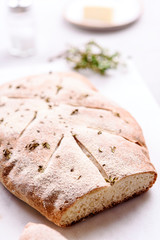 Homemade fresh baked Fougasse (French Bread) with thyme and olive oil on white background. Traditional Provencal dishes. Selective focus