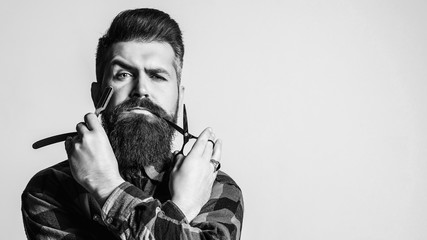 Barbershop advertising. Barber man with straight razor and scissors.