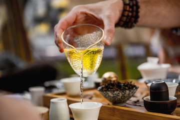 Tea ceremony set. teapot and man hand